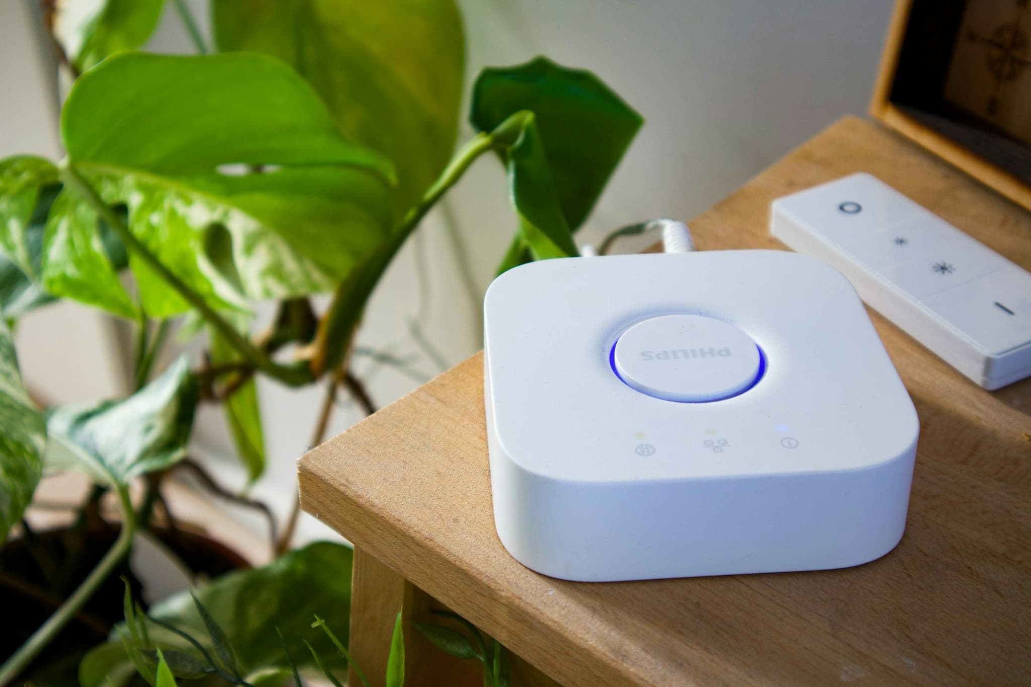 Smart home hub and remote on a wooden table