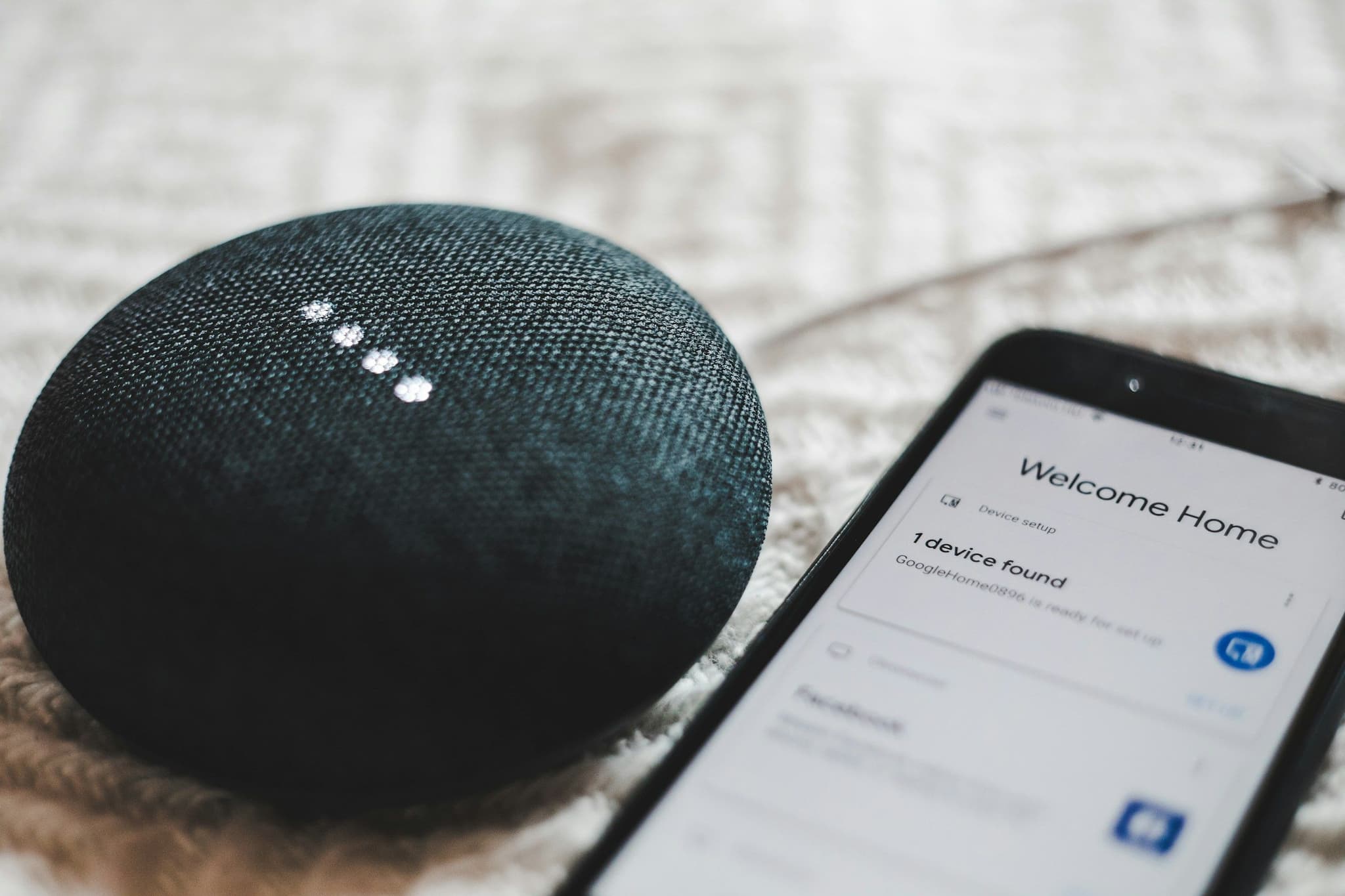 Google Home Mini next to a smartphone