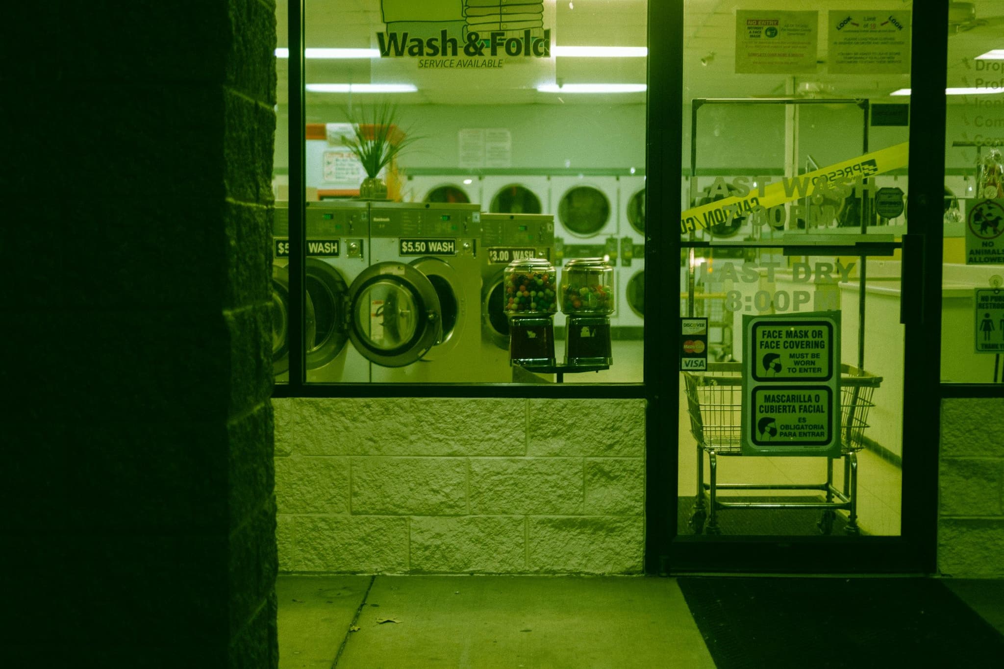 Row of white front-loading washing machines