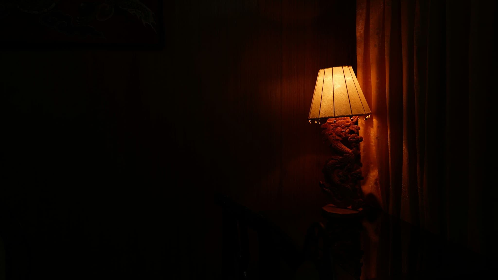 Lit table lamp in a dim room