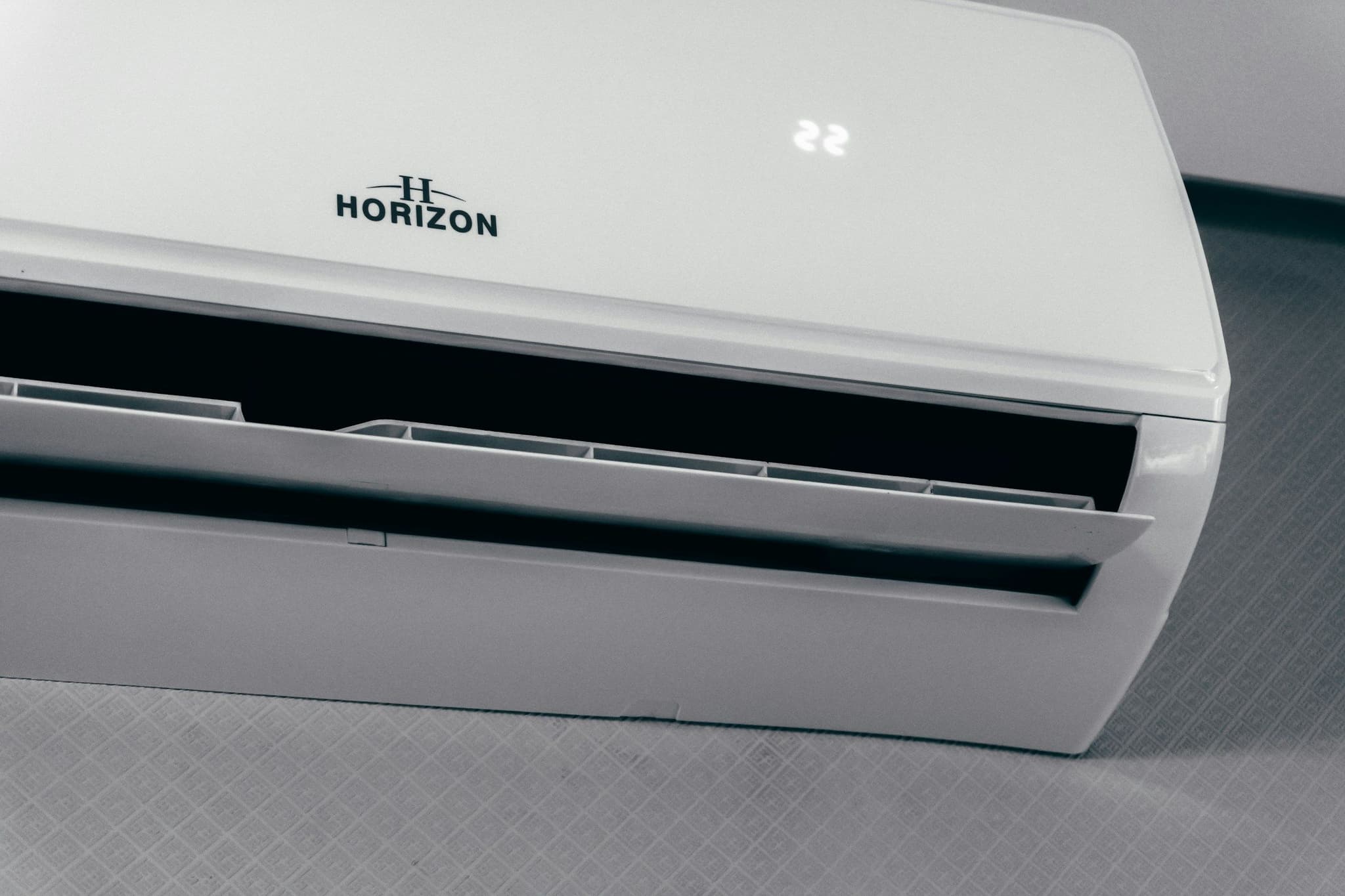 White wall-mounted air conditioner showing 22 degrees